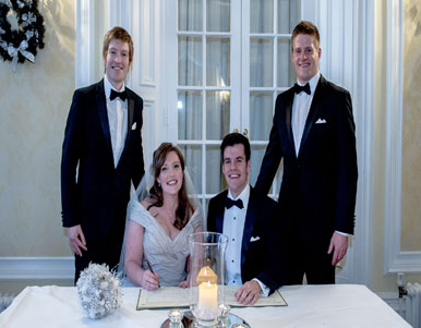Groomsmen and happy couple sign the register of marriage